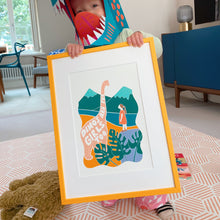 Load image into Gallery viewer, Little girl holding feminist dinosaur print with the wording &#39;Dino&#39;s are for girls too&#39;
