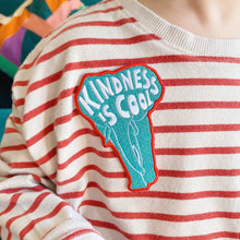 Load image into Gallery viewer, Elephant shaped embroidered kids badge/patch with the words/sloagn &#39;kindness is cool&#39; irons on and then sew into place. Sewn onto children&#39;s T-shirt. 
