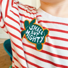 Load image into Gallery viewer, &#39;Small but mighty&#39; slogan kids embroidered patch, green, white and yellow, sewn onto girls T-shirt.
